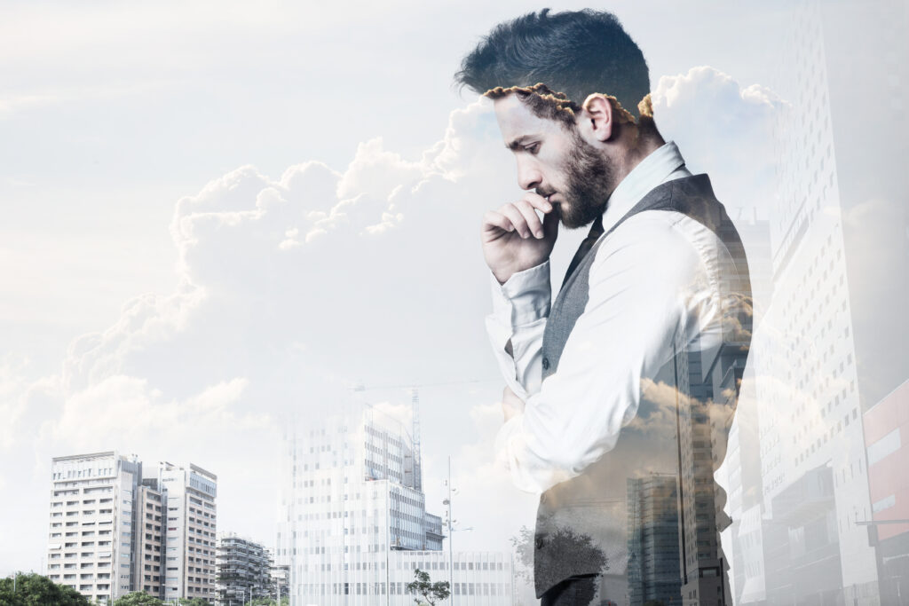 Portrait of double exposure of young businessman and city.